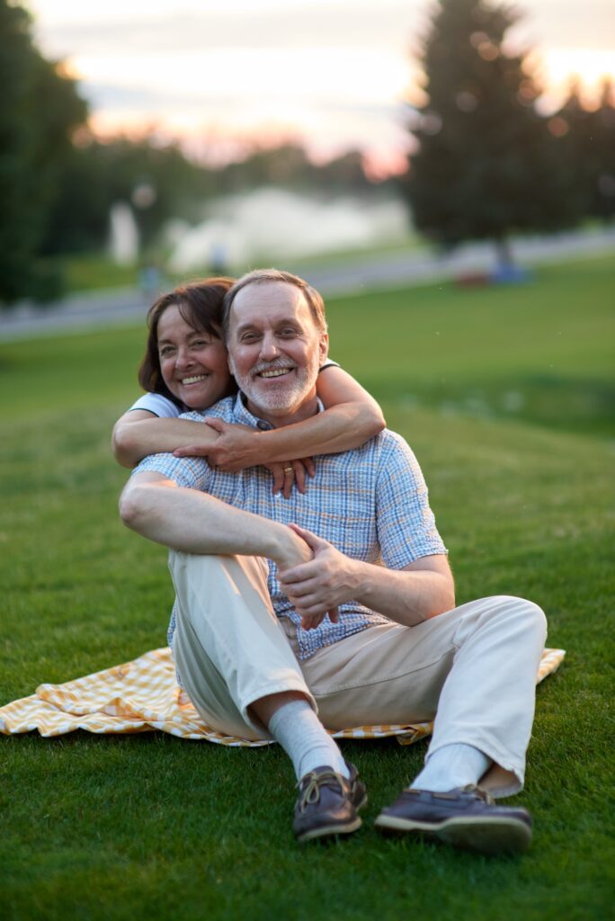 Happy mature lady hugging his husband from behind.